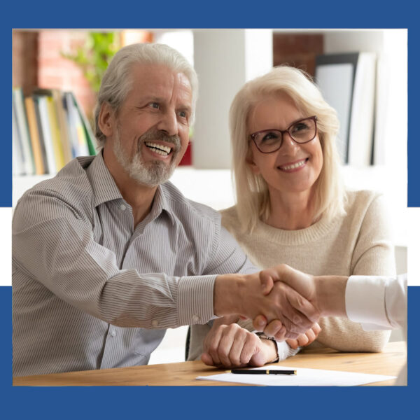 Happy senior old family couple clients make financial insurance estate business deal handshake agent lawyer, satisfied mature customers shake hand meeting bank manager agree on investment contract